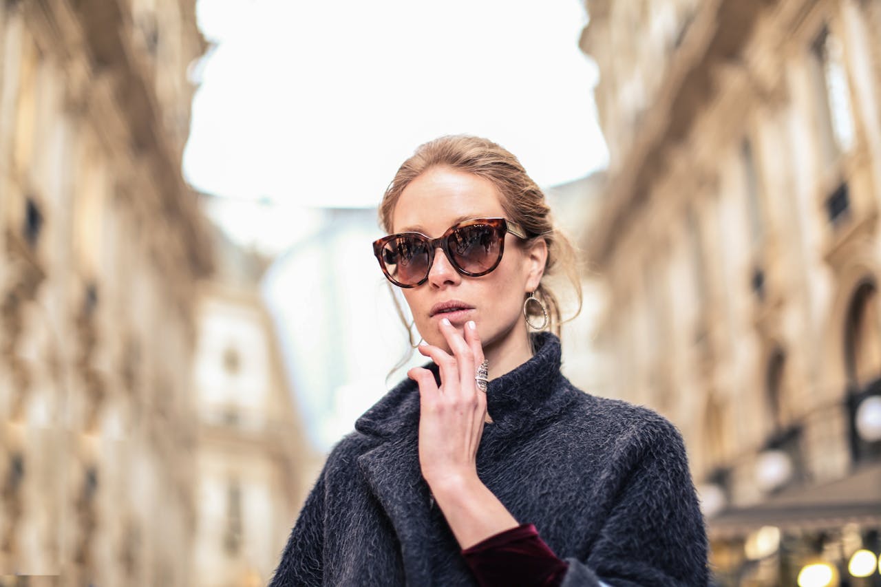 Crafting Captivating Headlines: Your awesome post title goes here Elegant woman in sunglasses posing outdoors in a fashionable street setting.